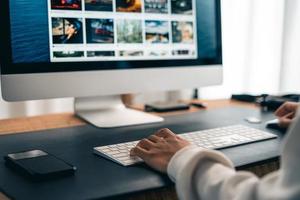 hombre que trabaja en el escritorio de la computadora en la oficina en casa foto