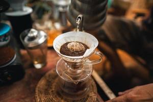 Closeup of hands barista make coffee photo