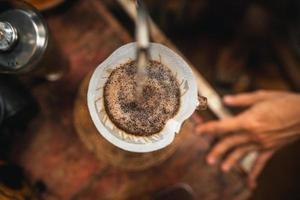 Closeup of hands barista make coffee photo