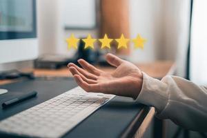 Hand and Phone With Five Star Rating photo