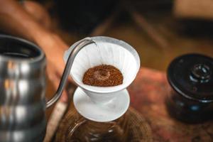 Closeup of hands barista make coffee photo