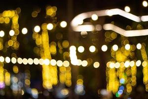 Decorative outdoor string lights hanging on tree in the garden at night time photo