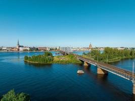 A bridge over river Daugava in Riga with a train passing by. photo