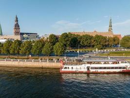 Small cruise ship taking tours down the river Daugava in Riga photo