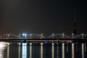 Night view of the railway bridge in Riga over river Daugava. photo