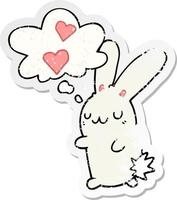 cartoon rabbit in love and thought bubble as a distressed worn sticker vector