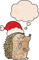 cartoon hedgehog wearing christmas hat and thought bubble in grunge texture pattern style vector