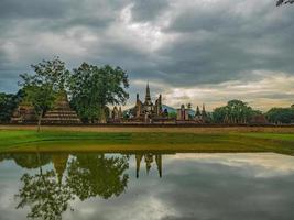 Ruin of Pagoda reflection in the water At sukhothai historical park,Sukhothai city Thailand photo