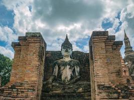 Ruin of ancient Statue in Wat mahathat Temple Area At sukhothai historical park,Sukhothai city Thailand photo