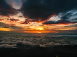Beautiful Sunrise Sky with Sea of the mist of fog in the morning on Khao Luang mountain in Ramkhamhaeng National Park,Sukhothai province Thailand photo