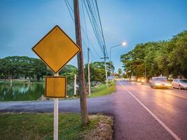 Mock up Yellow Traffic Sign Beside the Road photo