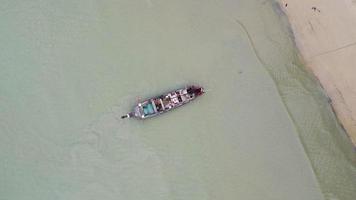 vista aérea desde drones de barcos de pesca en la orilla durante la marea baja. vista superior de muchos barcos de pesca tradicionales tailandeses de cola larga en las islas tropicales. un montón de botes de cola larga en el mar video