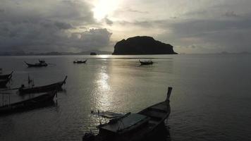 Aerial view from drones of fishing boats in the shore during low tide. Top view of many Thai traditional longtail fishing boats in the tropical islands. A lot of long tail boat on sea video