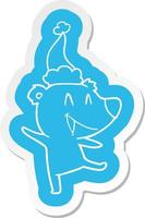 laughing bear cartoon  sticker of a wearing santa hat vector