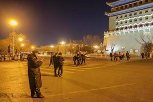 Beijing China - 24 February 2017 Unacquainted Chinese people or tourist walking in evening time at Zhengyang Gate Jianlou Qianmen street The famous street in beijing Capital City of china photo