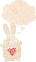 cute cartoon rabbit with love heart and thought bubble in retro textured style vector