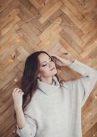 girl in sweater with closed eyes photo