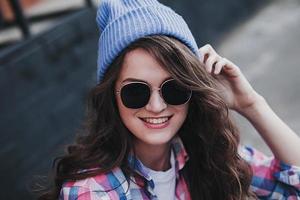 hipster woman smiling in urban background photo