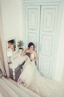 Beautiful young bride in white wedding dress photo