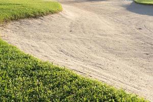 sandpit bunker beauty background is Used as an obstacle for golf tournaments for difficulty. and decorate the field for beauty.green grass with sand texture. photo