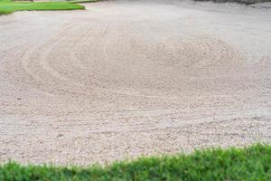 sandpit bunker beauty background is Used as an obstacle for golf tournaments for difficulty. and decorate the field for beauty.green grass with sand texture. photo