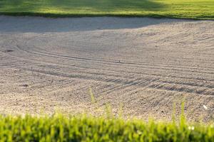 sandpit bunker beauty background is Used as an obstacle for golf tournaments for difficulty. and decorate the field for beauty.green grass with sand texture. photo