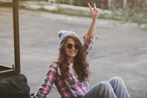 hipster woman smiling in urban background photo