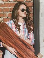 hipster girl holding a longboard photo