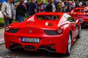 GERMANY, FULDA - JUL 2019 red FERRARI 458 SPIDER coupe was introduced at the 2011 Frankfurt Motor Show. This convertible variant of the 458 Italia features an aluminium retractable hardtop which, acco photo