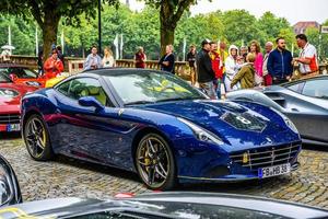 GERMANY, FULDA - JUL 2019 dark blue FERRARI CALIFORNIA Type F149 coupe is a grand touring sports car produced by the Italian automotive manufacturer Ferrari. It is a two-door hard top convertible. Whe photo