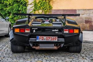 GERMANY, FULDA - JUL 2019 black LAMBORGHINI COUNTACH is a rear mid-engine, rear-wheel-drive sports car produced by the Italian automobile manufacturer Lamborghini from 1974 to 1990. It is one of the t photo