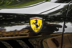 GERMANY, FULDA - JUL 2019 A close-up of the Ferrari logo on a black car photo