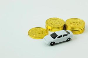 white car toy and gold coin on  white background. photo