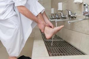 A Muslim takes ablution for prayer. Islamic religious rite photo