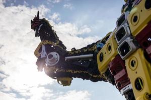 A low angle view of the robot's arm, which has been creatively crafted by using old steel. photo