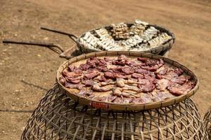 Plenty of sun-dried meat scattered on bamboo baskets to be exposed to the sun during the day. photo