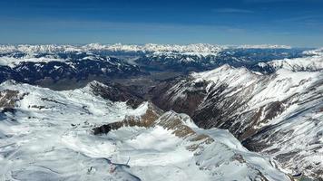 Amazing view from a drone over the snowy mountain hills photo