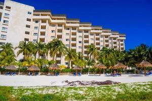 Hotel on the sandy beach on a sunny day in Cancun, Yukatan, Mexico photo