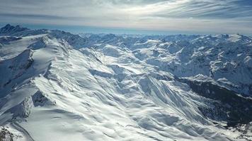 Amazing view from a drone over the snowy mountain hills photo