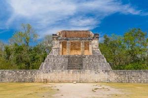 Temple of the Bearded Man at the end of Great Ball Court for playing pok-ta-pok near Chichen Itza pyramid, Yucatan, Mexico. Mayan civilization temple ruins, archeological site photo