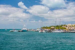 Port with sailboats and ships in Isla Mujeres island in Caribbean Sea, Cancun, Yucatan, Mexico photo