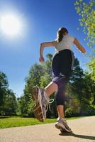 Young beautiful  woman jogging at morning in park photo