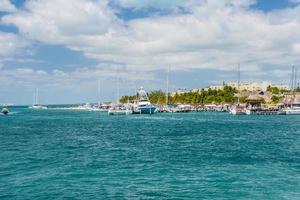 Port with sailboats and ships in Isla Mujeres island in Caribbean Sea, Cancun, Yucatan, Mexico photo