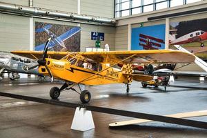 FRIEDRICHSHAFEN - MAY 2019 yellow plane PIPER J3 CUB at Motorworld Classics Bodensee on May 11, 2019 in Friedrichshafen, Germany photo