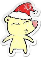 distressed sticker cartoon of a whistling bear wearing santa hat