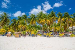 Cocos beach bar on a beach with white sand and palms on a sunny day, Isla Mujeres island, Caribbean Sea, Cancun, Yucatan, Mexico photo