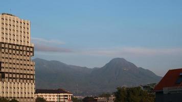 In the morning, you can see apartments next to residents' houses and adjacent to the mountain photo