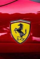 GERMANY, FULDA - JUL 2019 A close-up of the Ferrari logo on a red car photo