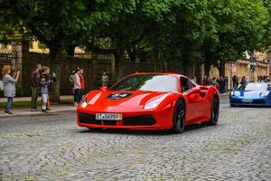 GERMANY, FULDA - JUL 2019 red FERRARI 488 coupe Type F142M is a mid-engine sports car produced by the Italian automobile manufacturer Ferrari. The car is an update to the 458 with notable exterior and photo