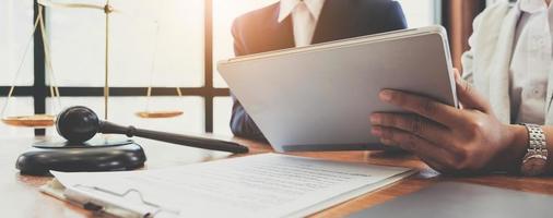 Consultation of Businessman or lawyer team meeting with client, Law and Legal services concept, Good service cooperation, Hands using tablet and laptop. photo